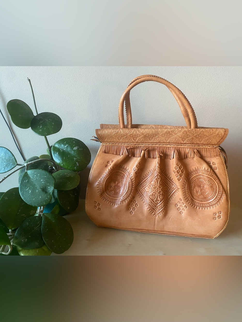 Genuine leather structured handbag with embossed print